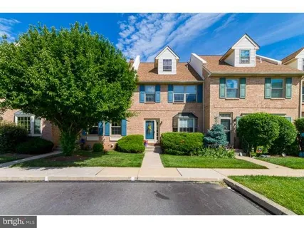 a front view of a house with a yard and a garage