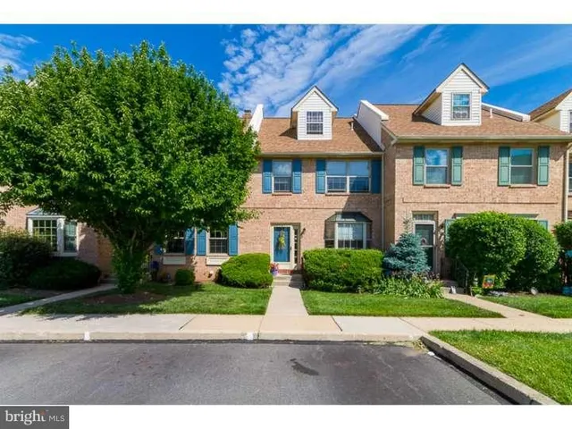 a front view of a house with a yard and a garage