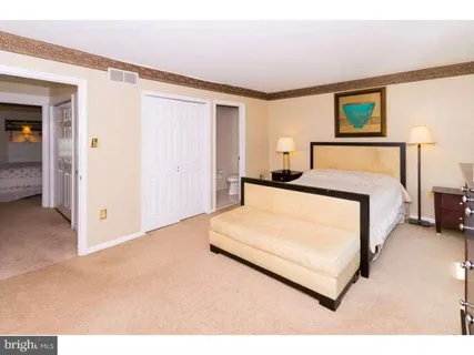 a living room with furniture gym equipment and a large window