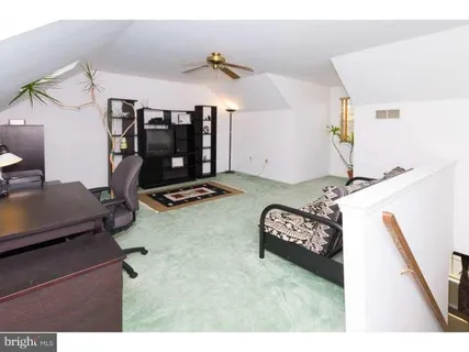 a view of a room with furniture and a flat screen tv