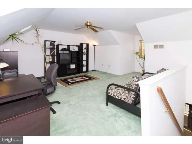 a view of a room with furniture and a flat screen tv