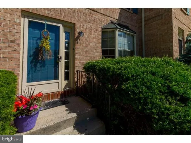 a view of a house with potted plants