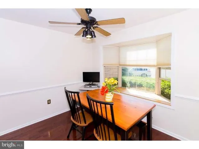 a view of a dining room with a table and chairs