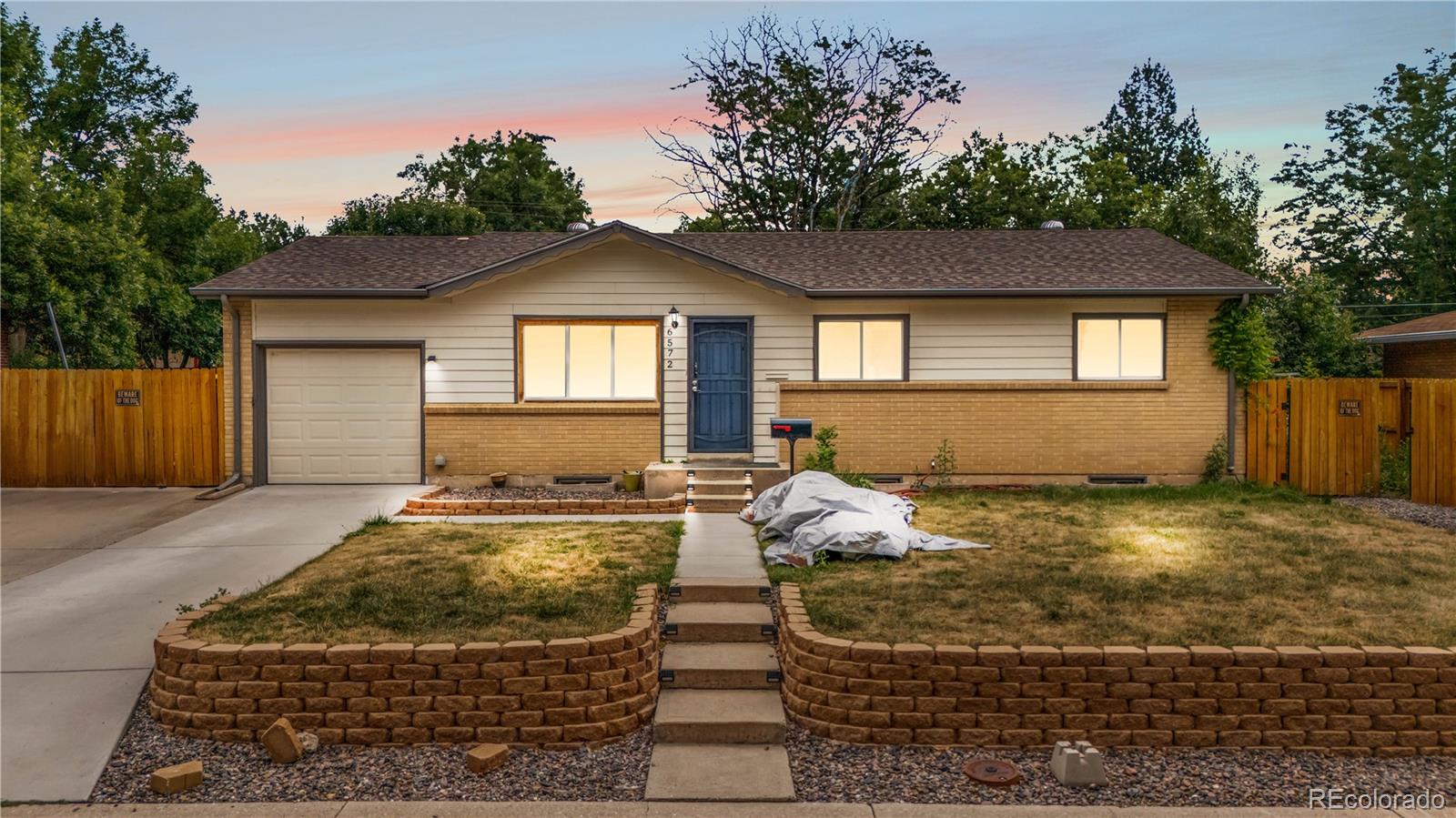 6572 Kipling Street Arvada, CO 80004 - Photo 1 of 18 a front view of a house with garden