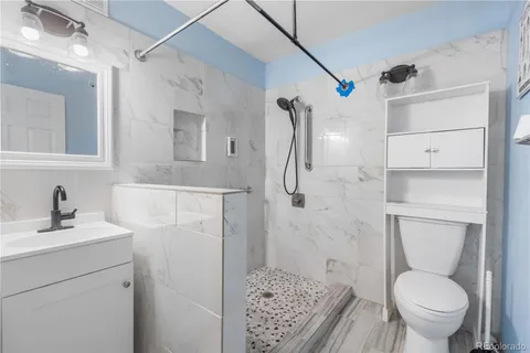 a bathroom with a sink toilet and shower
