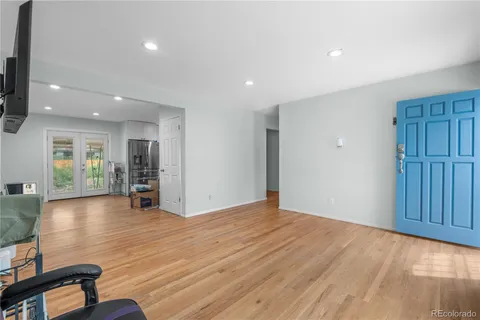 a view of empty room with wooden floor and stairs
