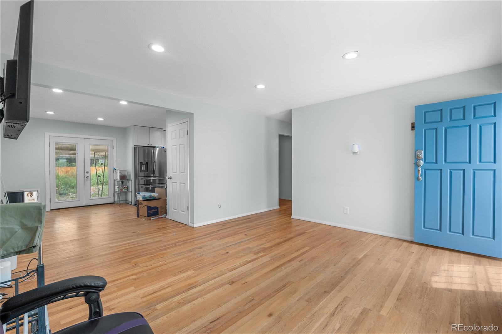 6572 Kipling Street Arvada, CO 80004 - Photo 4 of 18 a view of empty room with wooden floor and stairs