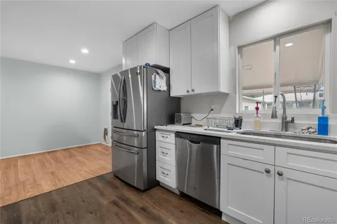 a kitchen with stainless steel appliances a refrigerator sink and cabinets