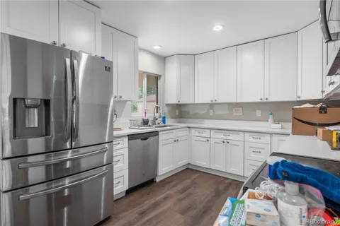 a kitchen with a refrigerator stove and sink
