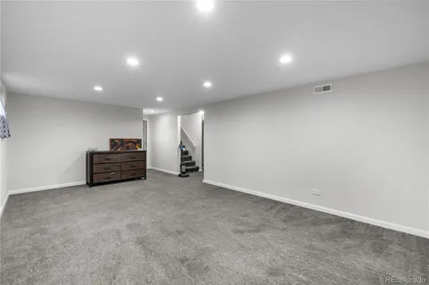 a view of empty room with stairs