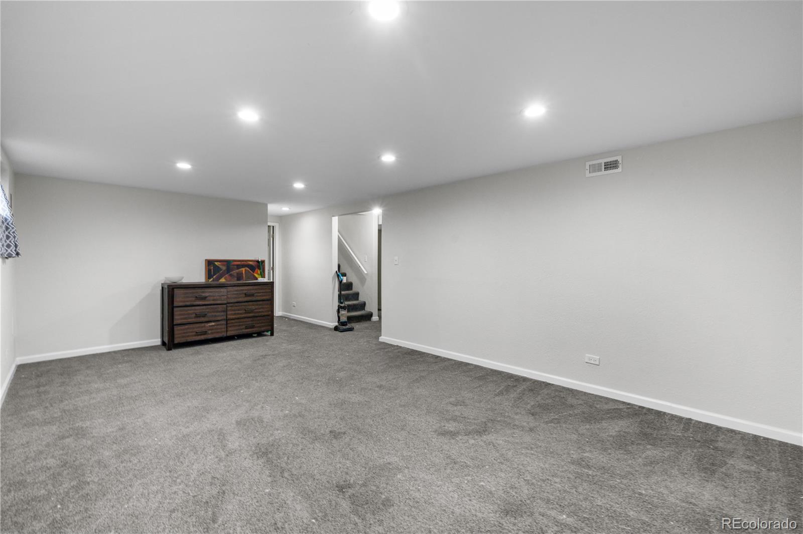 6572 Kipling Street Arvada, CO 80004 - Photo 10 of 18 a view of empty room with stairs