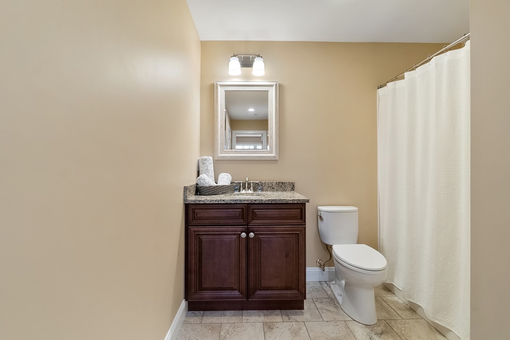 4 Sabrina Way, Unit D Feeding Hills, MA 01030 - Photo 23 of 34 a bathroom with a toilet a sink and mirror