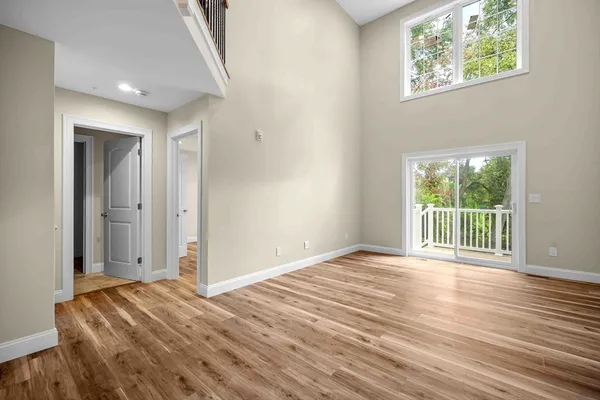a view of a room with wooden floor and large window