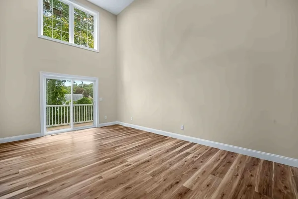 a view of a livingroom with wooden floor and a ceiling fan