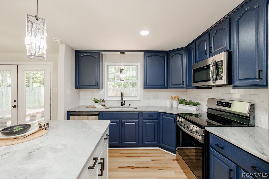 4719 Mill Park Circle Glen Allen, VA 23060 - Photo 18 of 49 a kitchen with a sink stove top oven and wooden cabinets