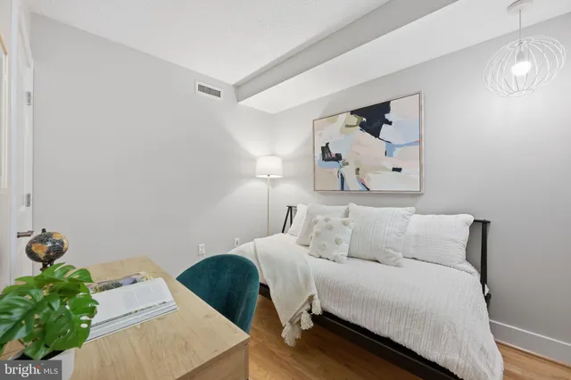 a bedroom with a bed and a lamp