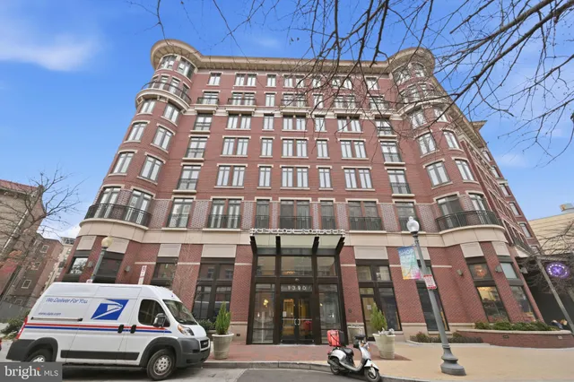 a room with furniture and view of kitchen