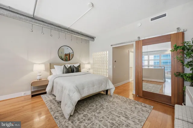 a bedroom with a bed and a large window