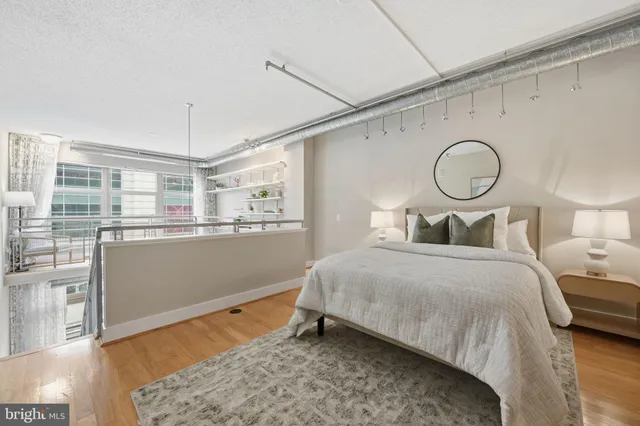 a bedroom with a bed and wooden floor