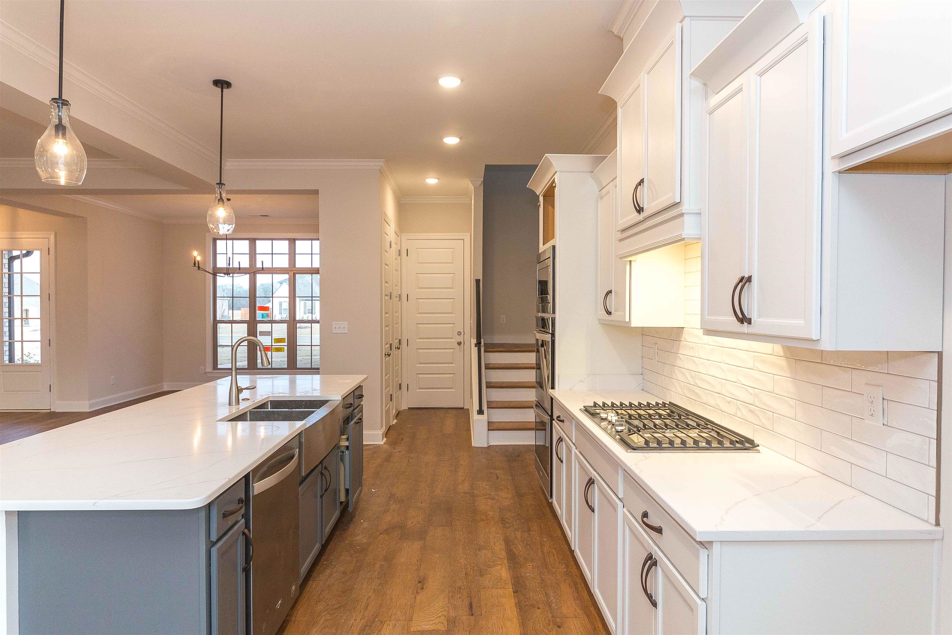 6441 Mccord Loop Arlington, TN 38002 - Photo 4 of 23 a kitchen with kitchen island granite countertop a sink stove and refrigerator