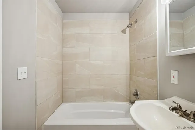 a bathroom with a bathtub and shower