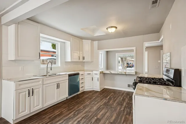 a kitchen with a sink stove and cabinets