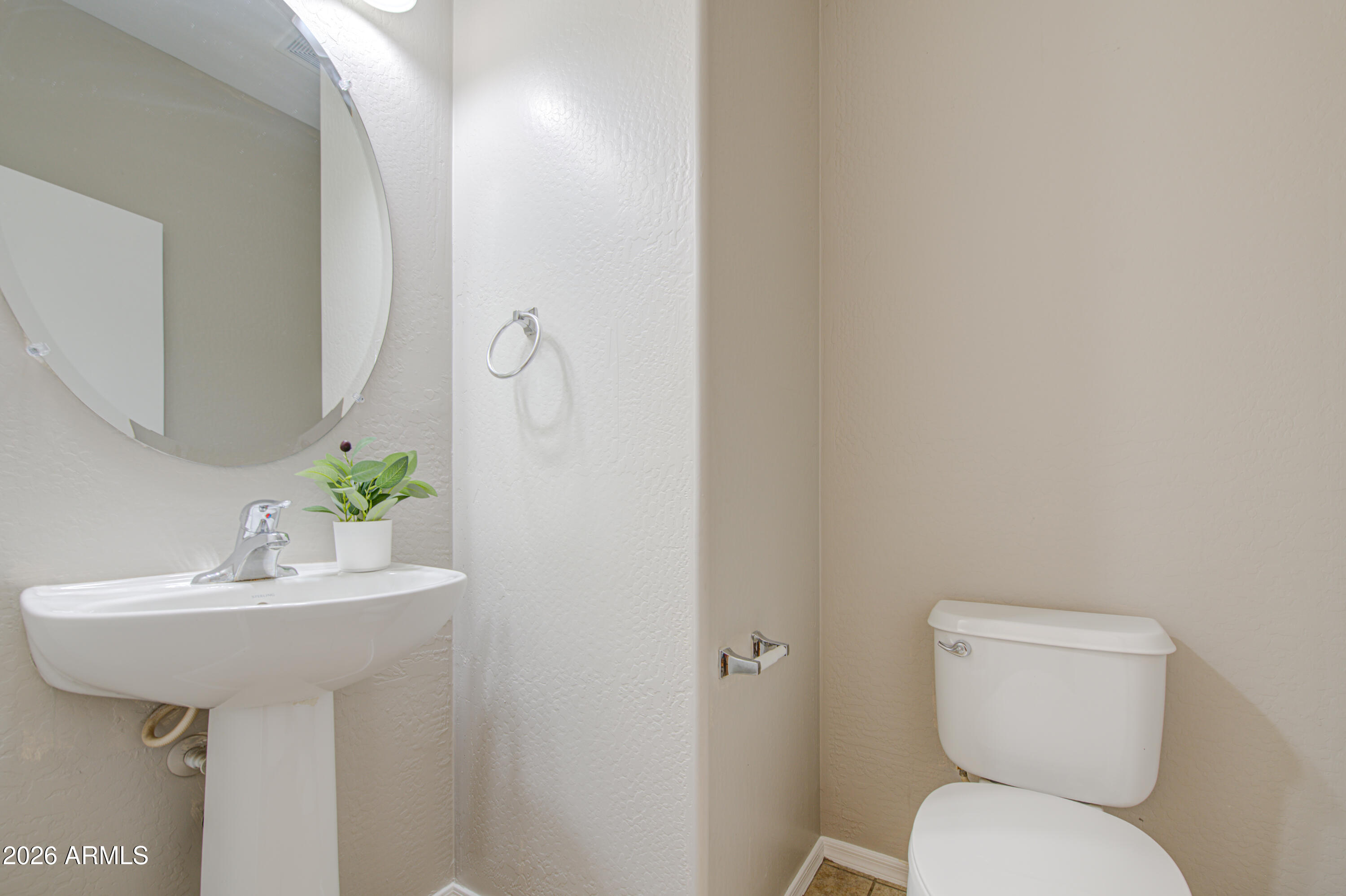 7759 West Monte Vista Road Phoenix, AZ 85035 - Photo 40 of 43 a bathroom with a sink toilet and a mirror