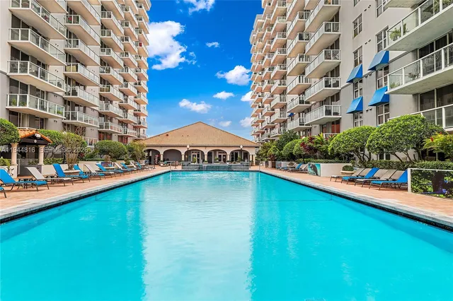 a view of a swimming pool with outdoor seating