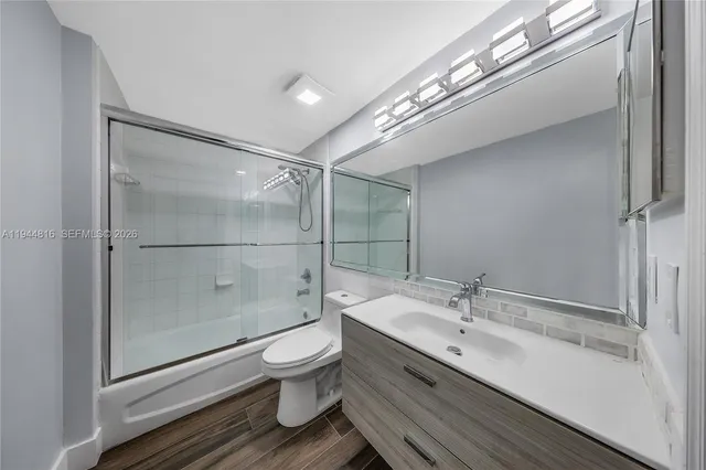 a bathroom with a sink shower and a mirror