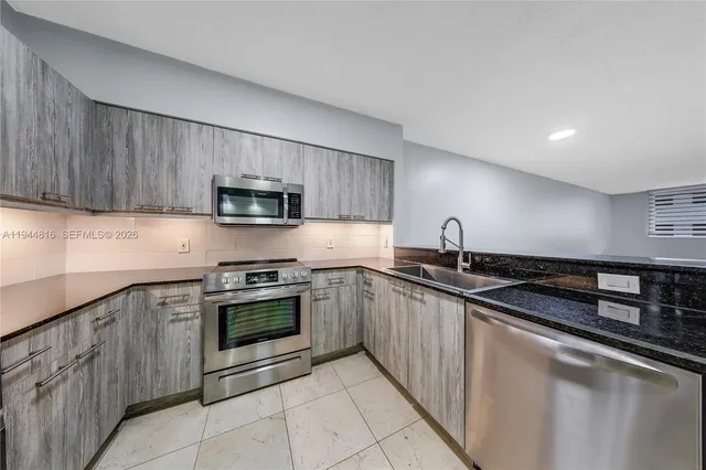 a kitchen with stainless steel appliances granite countertop a sink and stove top oven