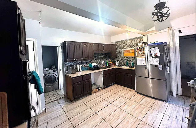 a kitchen with stainless steel appliances granite countertop a refrigerator and a stove top oven
