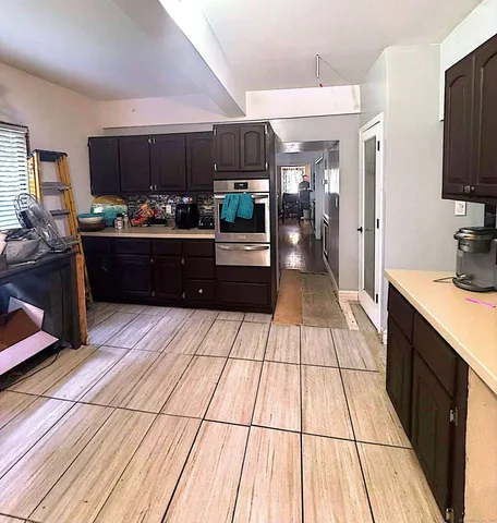 a kitchen with stainless steel appliances kitchen island granite countertop a sink counter space and cabinets