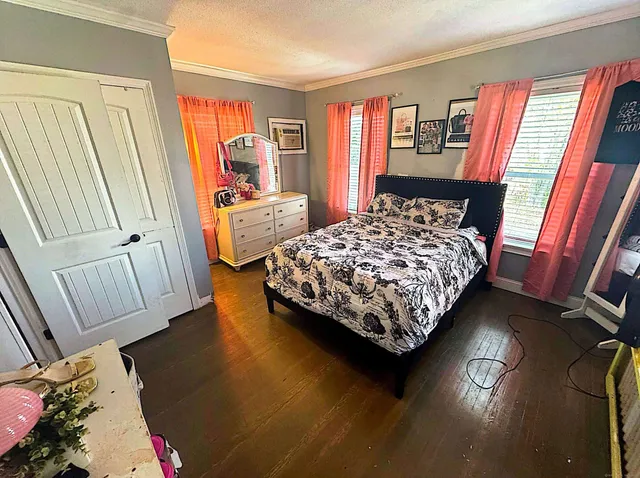 a bed sitting in a bedroom next to a window