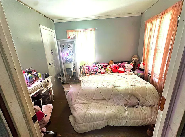 a bedroom with a bed closet and a large mirror