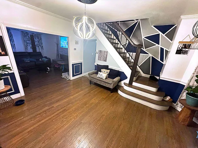 a living room with wooden floor furniture and a wooden floor