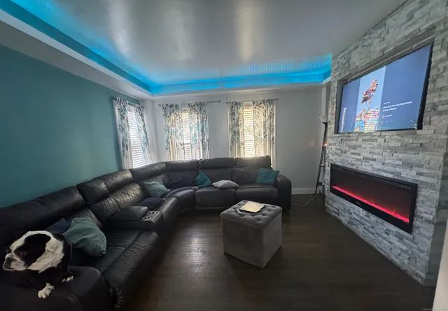 a living room with furniture and a fireplace