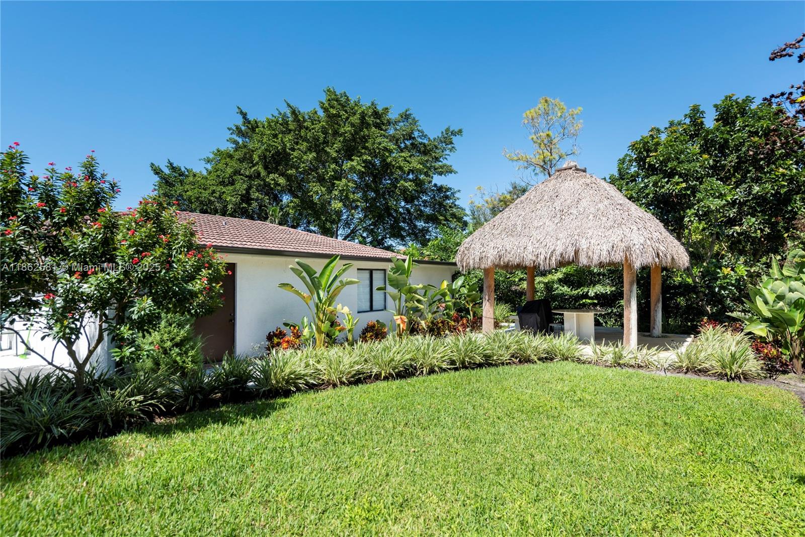 5960 Southwest 190th Avenue Southwest Ranches, FL 33332 - Photo 13 of 32 a front view of a house with garden