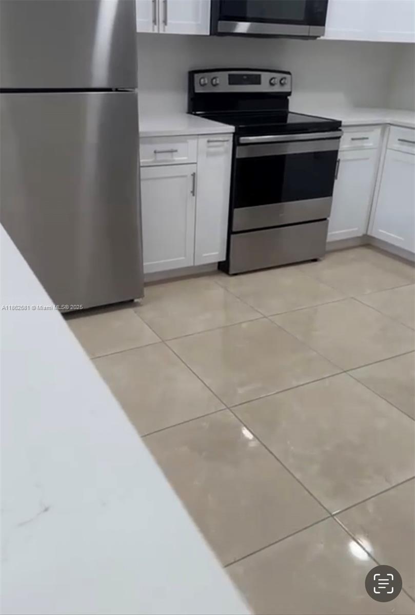 5960 Southwest 190th Avenue Southwest Ranches, FL 33332 - Photo 15 of 32 a kitchen with a stove and a refrigerator