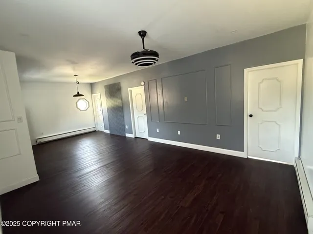 a view of room with window and wooden floor