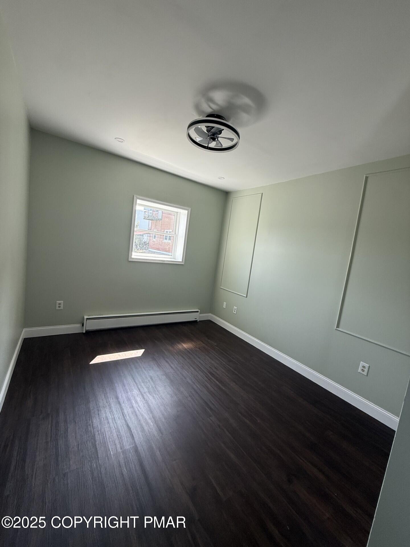 132 East Main Street, Unit 1C Girardville, PA 17935 - Photo 9 of 13 an empty room with wooden floor and windows