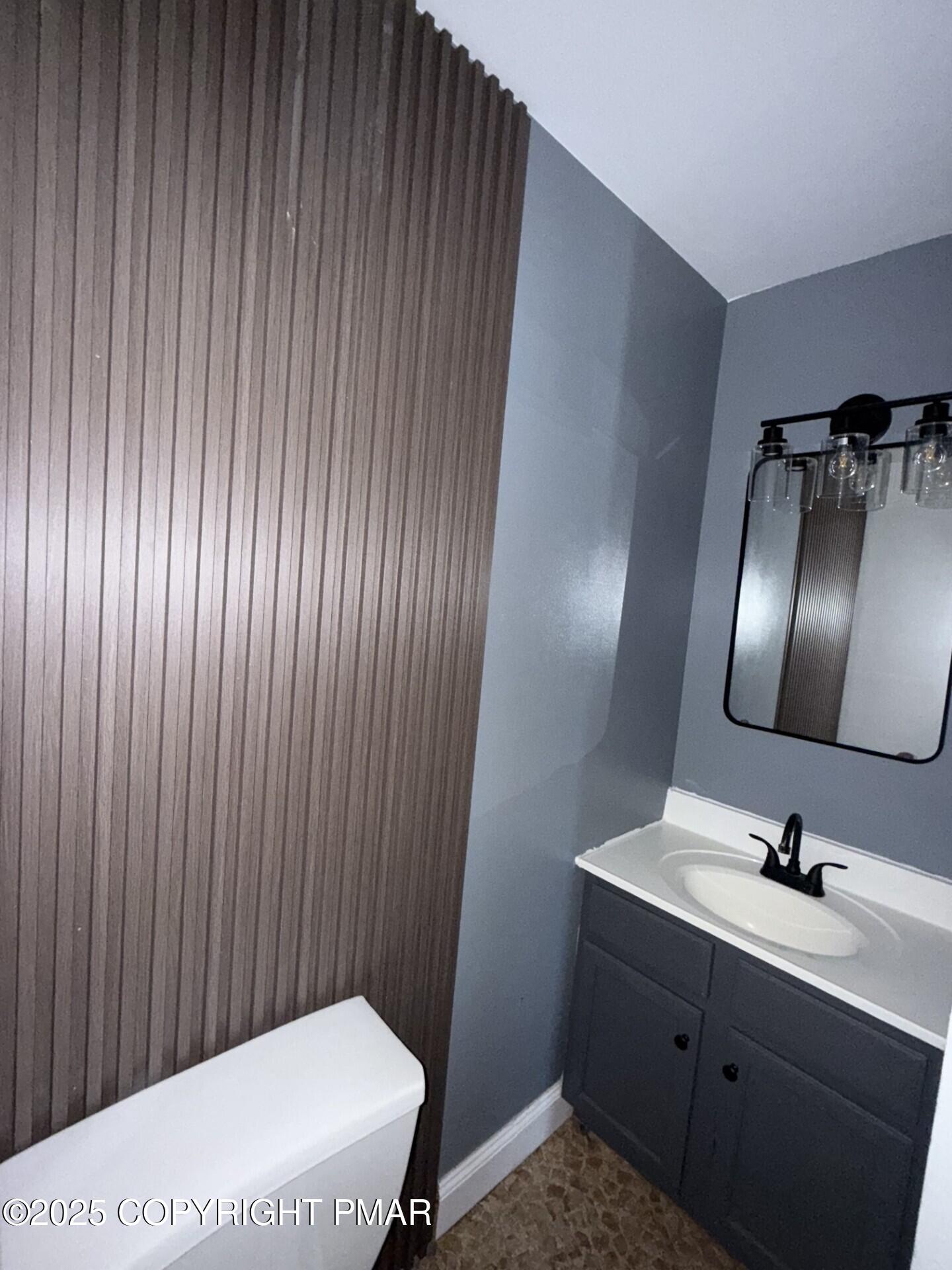 132 East Main Street, Unit 1C Girardville, PA 17935 - Photo 10 of 13 a bathroom with a sink a toilet and mirror