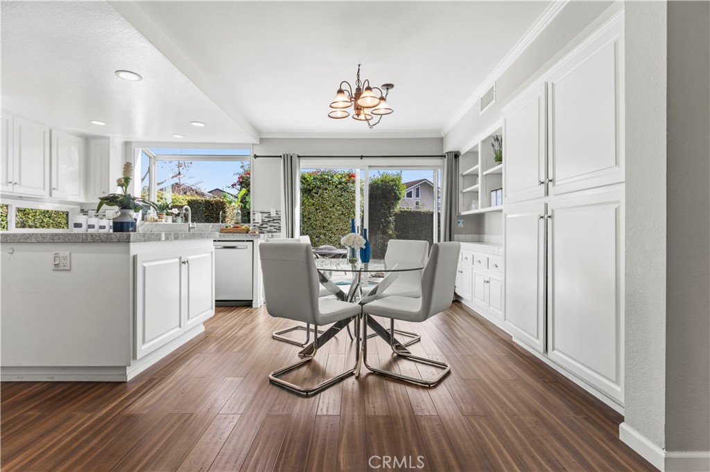 13 Recodo Irvine, CA 92620 - Photo 16 of 71 a kitchen with stainless steel appliances a dining table chairs stove and white cabinets