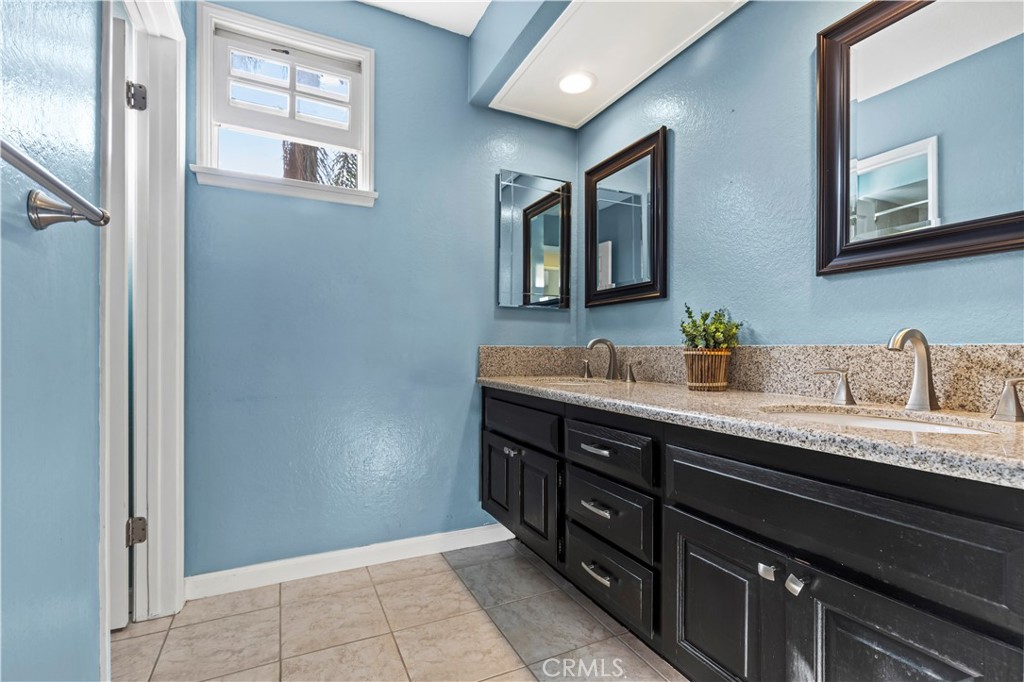 13 Recodo Irvine, CA 92620 - Photo 29 of 71 a bathroom with a granite countertop sink and a mirror