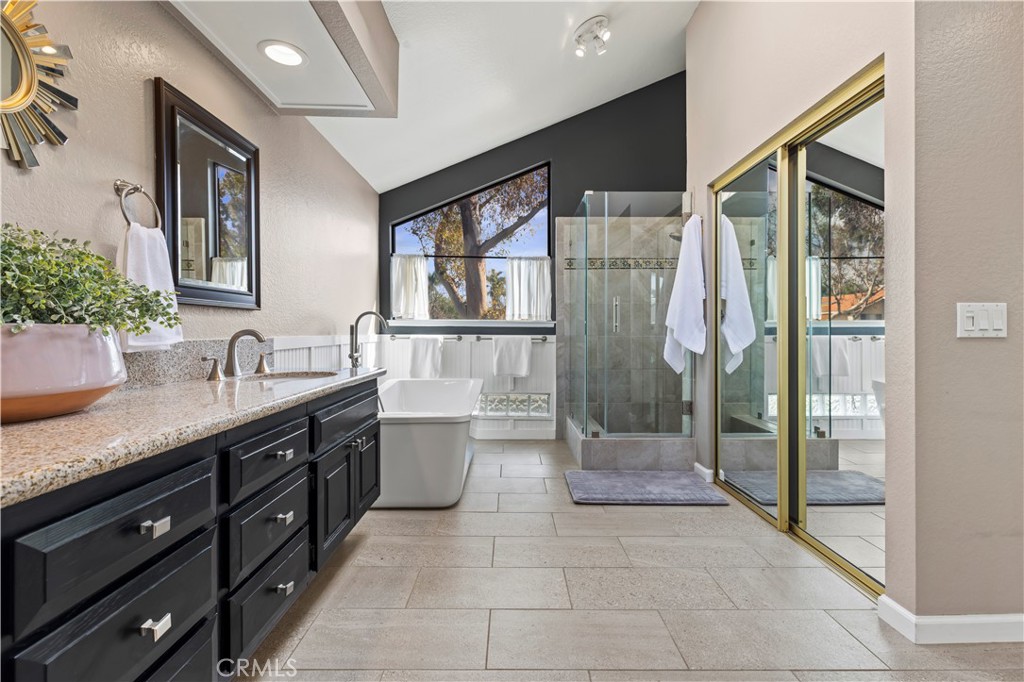 13 Recodo Irvine, CA 92620 - Photo 37 of 71 a spacious bathroom with a granite countertop sink a mirror and a shower