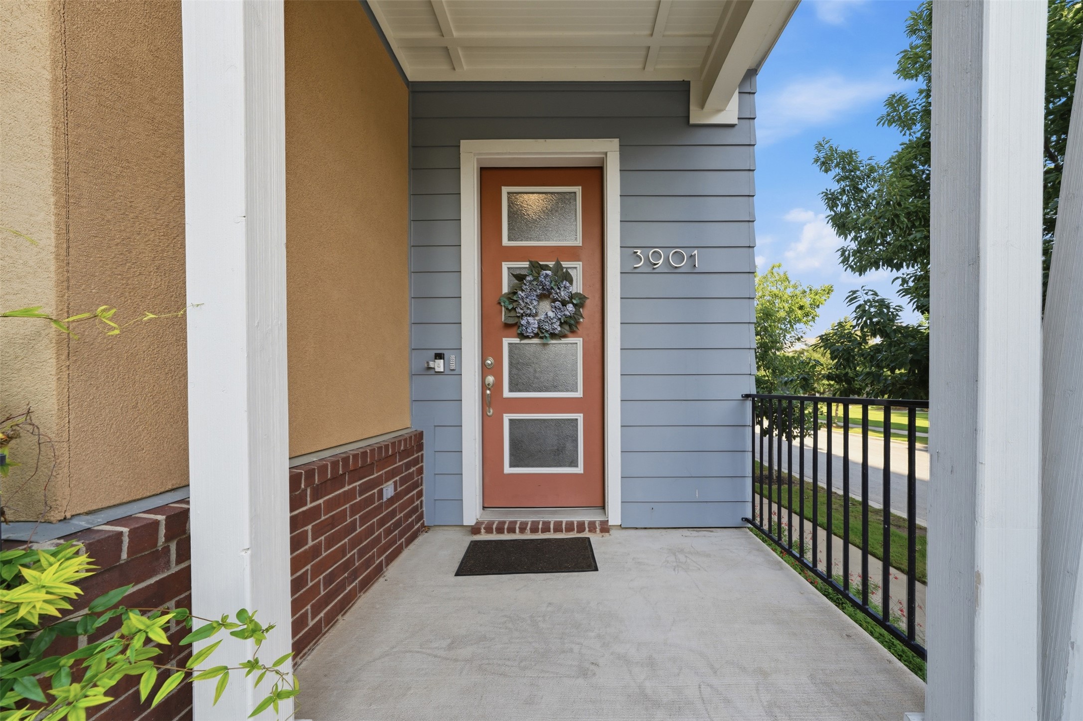 3901 Vaughan Street Austin, TX 78723 - Photo 3 of 37 Inviting front entrance featuring a panel door with frosted glass inserts, a covered concrete porch, horizontal siding, and a brick foundation
