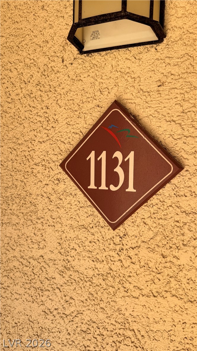 7885 West Flamingo Road, Unit 1131 Las Vegas, NV 89147 - Photo 12 of 36 Welcome home to this charming residence featuring a distinctive address plaque and outdoor lighting.