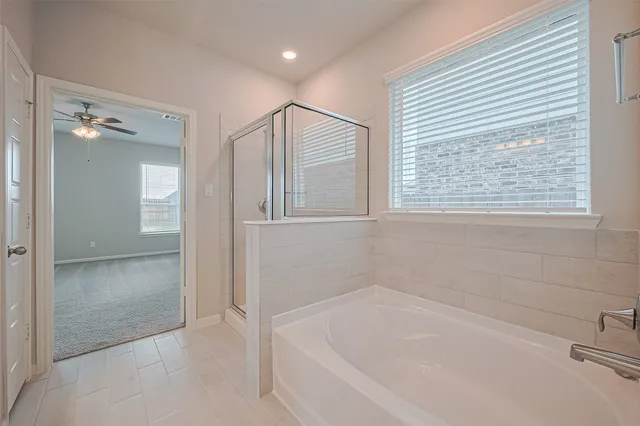 a bathroom with a bathtub and shower