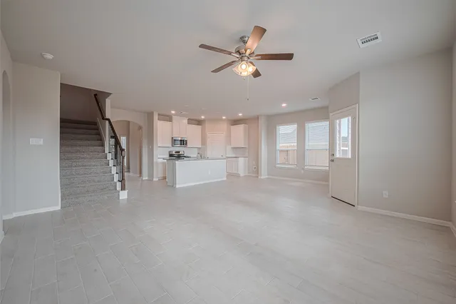 a view of a livingroom with a ceiling fan and window