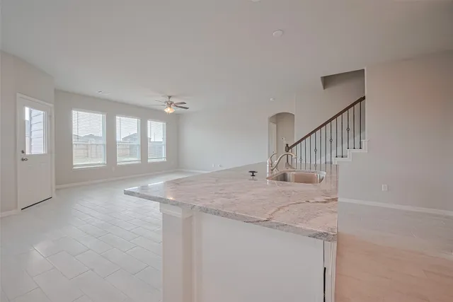 a view of a livingroom with wooden floor and stairs