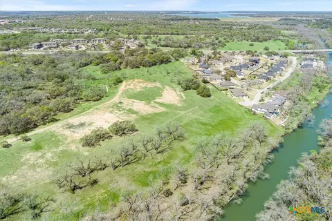 a view of a lake with green field